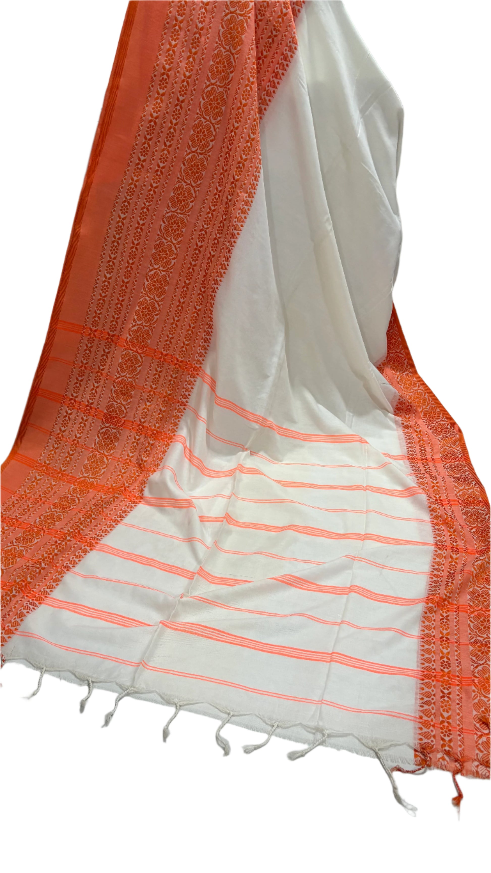 White saree with orange border draped over a surface