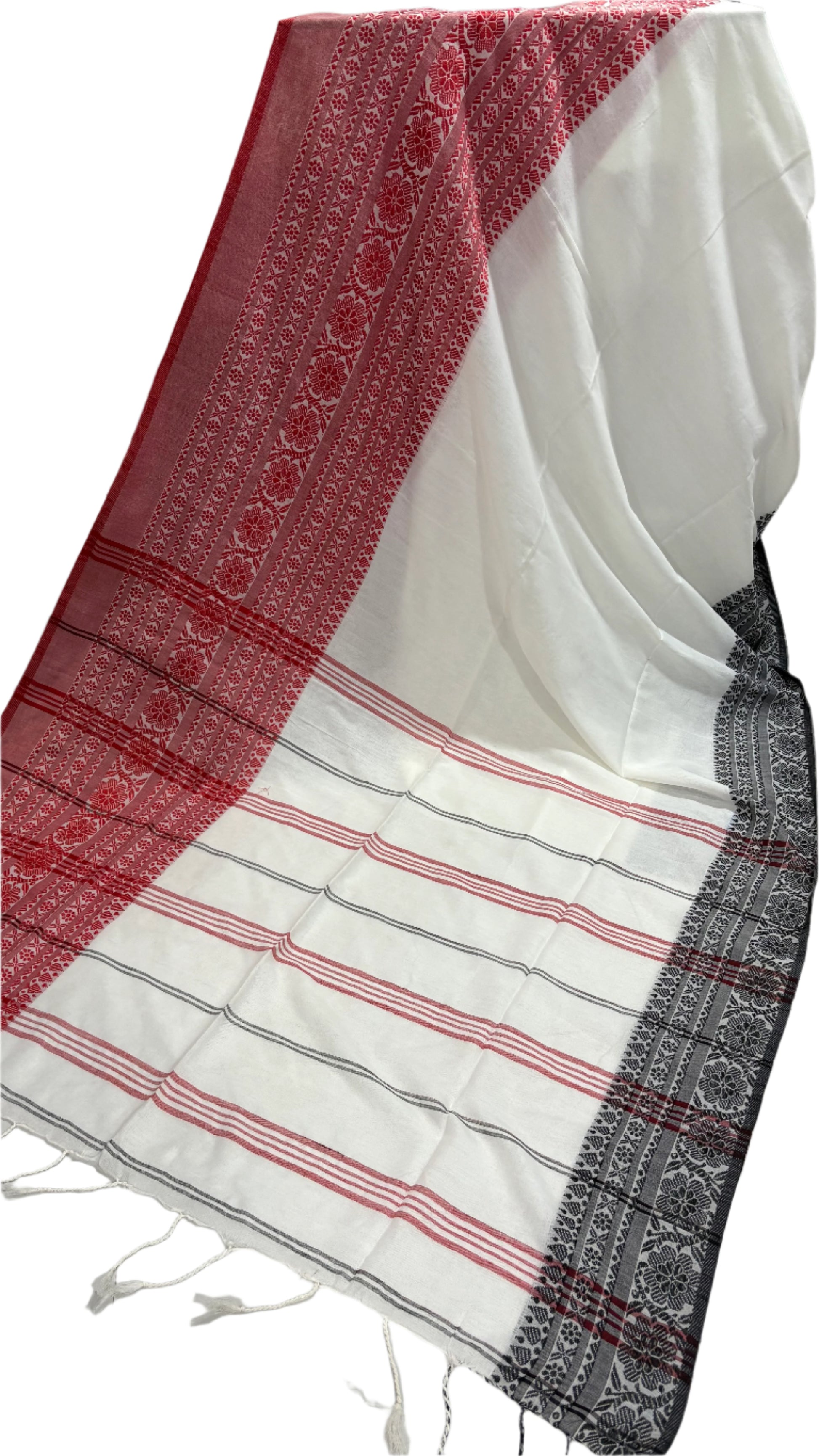 White saree with red and black patterns on a white background
