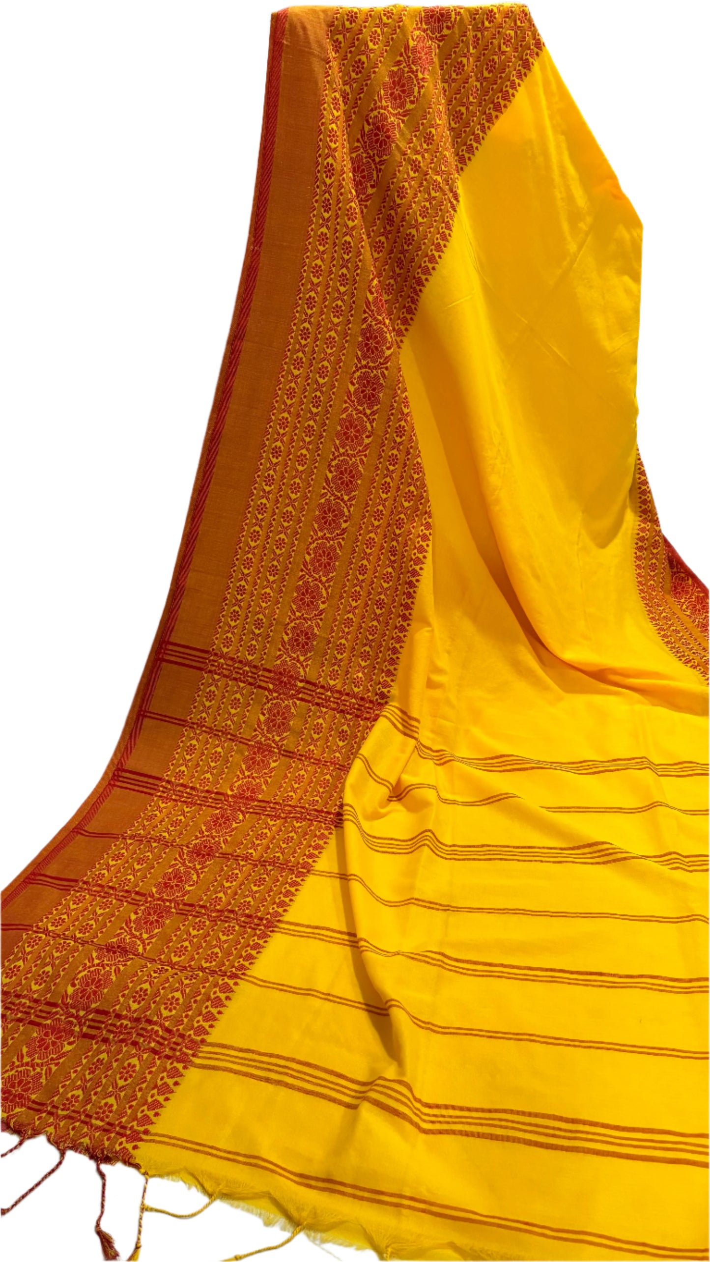 Yellow saree with red patterns on a white surface